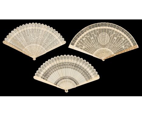 Chinese. A pierced and carved ivory brisé fan, early 19th century, the sticks finely pierced and carved with scrolling flower