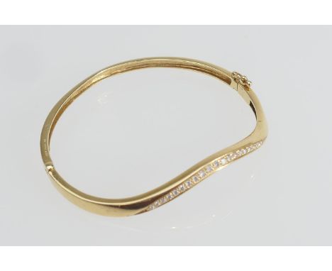 18ct yellow gold and diamond bangle, channel set with 21 small brilliant cut stones, cuff size 57mm, fully hallmarked, gross 