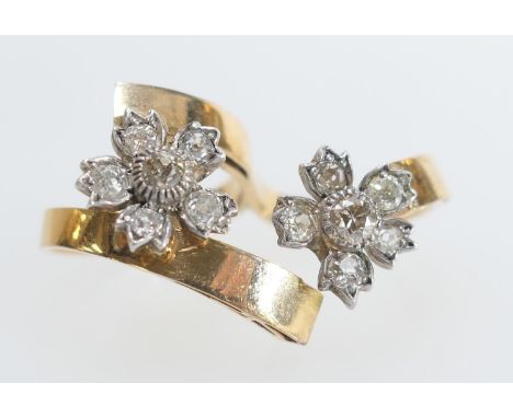 18ct yellow gold and diamond double finger ring, set with two flowerhead diamond clusters with old round and cushion cut ston