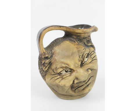 Martin Brothers stoneware double face jug, dated 1903, modelled in bas-relief with a smiling face opposing a grimacing face, 