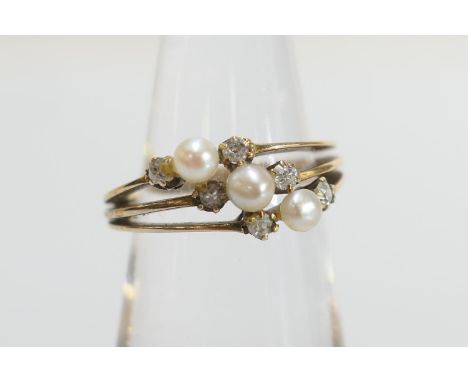 Diamond and pearl trinity ring, set with three small pearls of approx. 3mm diameter flanked by six cushion cut diamonds, in 1
