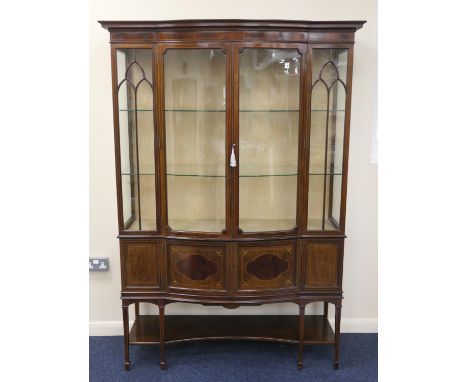 Late Victorian or Edwardian mahogany and inlaid bowfront display cabinet, retailed by Maple &amp; Co., centred with two glaze