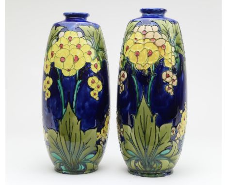 Matched pair of Minton Secessionist vases, circa 1900, decorated with stylised yellow flowers with green foliage against a bl