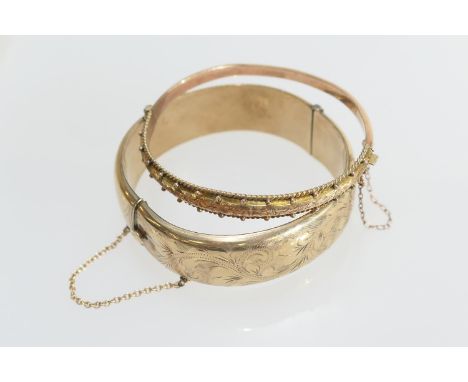 9ct gold hinged hollow bangle with foliate engraved decoration, width 17mm, cuff size 58mm (with visible dents); also an Edwa