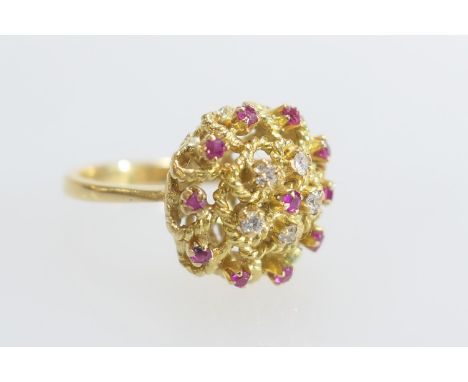 Eastern ruby and diamond cluster ring in 18ct gold, the tiny stones set in an open knotted rope setting, size N, gross weight