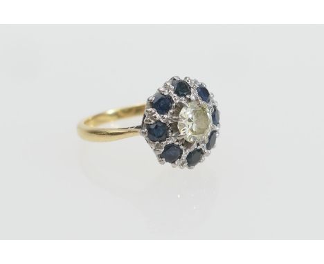 Diamond and sapphire cluster ring, centred with an old cut round diamond of approx. 0.75ct, estimated as L/M in colour, and c