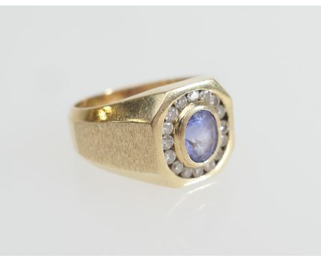 Tanzanite and diamond cluster ring, in 14ct gold, the central oval cut tanzanite bordered with tiny round cut channel set dia
