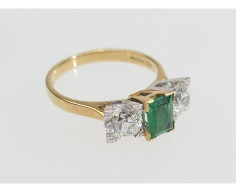 Emerald and diamond three stone ring, the central emerald of approx. 0.75ct flanked by two old round cut diamonds, each weigh
