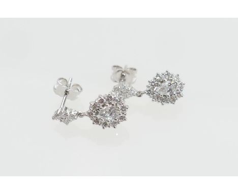 Pair of diamond cluster pendant earrings, each centred with a pear cut diamond of approx. 0.25ct, estimated as H/J in colour,