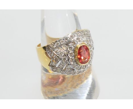 Fire opal and diamond cluster ring, the central oval cut reddish-orange gemstone of approx. 7mm x 4.5mm set in a yellow gold 