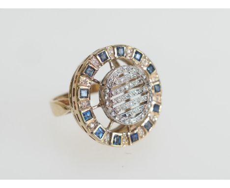 Unusual diamond and sapphire cluster ring, set with rose cut diamonds in a circular grid encircled with square cut sapphires 
