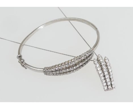 Diamond and white metal bangle and matching pendant necklace, the bangle set with 54 diamonds in a three row open setting, on