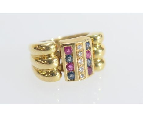Diamond, ruby and sapphire dress ring, the small round cut stones channel set in three rows, on an 18ct yellow gold ring, siz