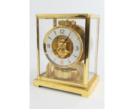 Jaeger-LeCoultre brass Atmos clock, white chapter ring with Arabic and baton numerals, height 22.5cm, width 18cmPlease note o