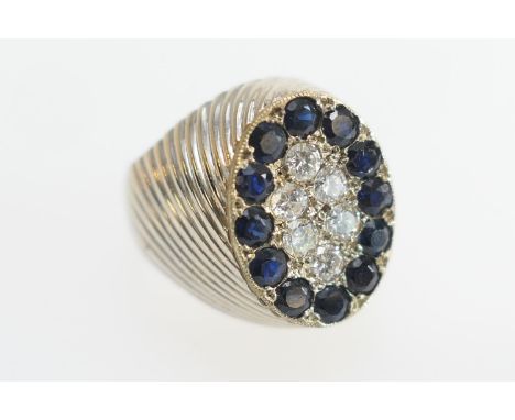 Sapphire and diamond pave set ring, centred with six small brilliant cut diamonds and bordered with twelve similar sized roun
