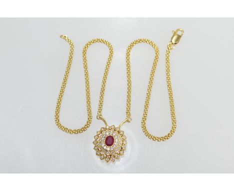 Ruby and diamond cluster pendant necklace, centred with an oval ruby of approx. 1ct, bordered with three rows of round cut di