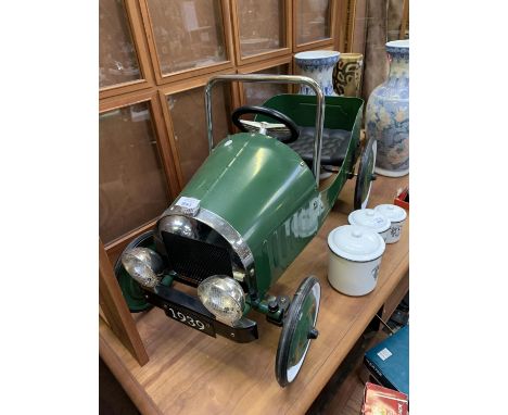 A CHILD'S METAL PUSH ALONG CLASSIC CAR IN RACING GREEN 