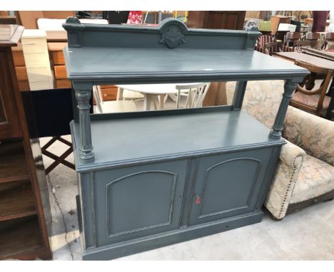 A GREEN PAINTED SIDEBOARD WITH UPPER SHELF AND TWO LOWER DOORS 