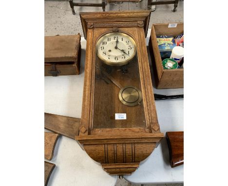A VINTAGE OAK CASED CHIMING WALL CLOCK WITH PENDULUM 