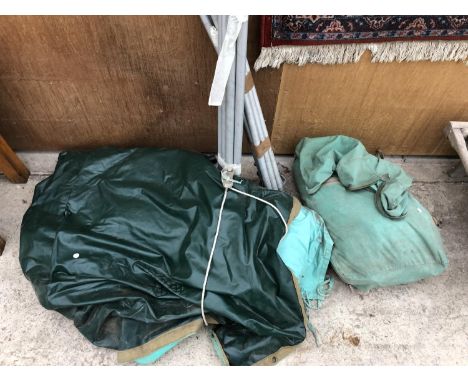 A VINTAGE GREEN CANVAS TENT WITH METAL POLES 