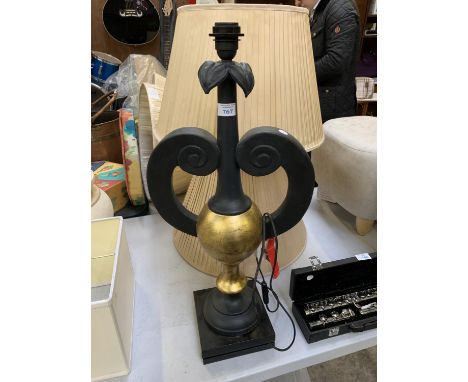 A BLACK AND GOLD LAMP BASE TOGETHER WITH TWO SHADES 