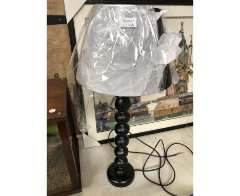A MODERN BLACK LAMP BASE WITH SHADE 