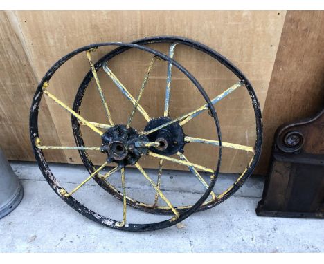 A PAIR OF VINTAGE CAST METAL WHEELS 
