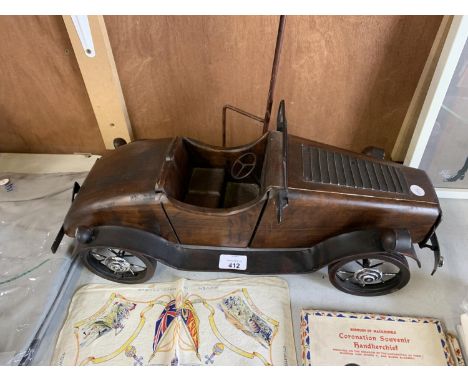 A VINTAGE WOODEN AND METAL CAR MODEL 