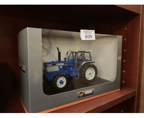 A UNIVERSAL HOBBIES FORD TW25 FORGE II 1-32 SCALE , ITEM NO UH4028 MODEL BOXED AND IN MINT CONDITION 