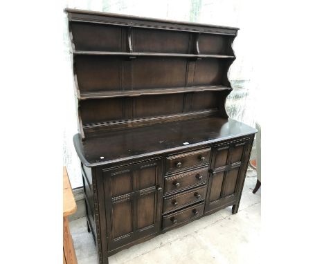 AN ERCOL ELM DRESSER WITH TWO DOORS FOUR DRAWERS AND UPPER SPLASHBACK 