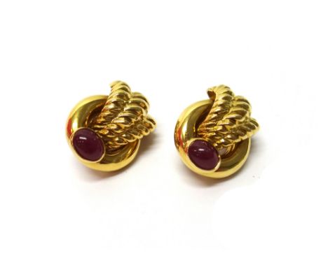 A pair of gold and cabochon ruby set earclips, by Piranesi, each of plain circular hoop and triple fanned design and mounted 