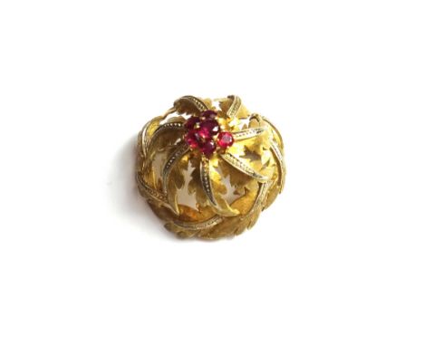 An 18ct gold and ruby set brooch, in a foliate design, claw set with six circular cut rubies, (one further ruby lacking), gro