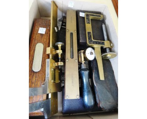 A Troughton & Simms brass micrometer measuring caliper, an early steel and brass mounted level in an oak case, an unusual G s