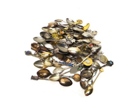 A collection of sixty-eight mostly plated souvenir and commemorative spoons, including a few silver examples, with a wooden d