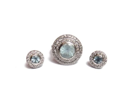 A diamond and aquamarine set circular cluster ring, collet set with the circular cut aquamarine at the centre, in a two row o