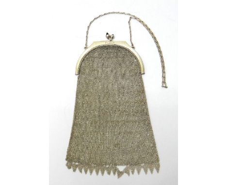 A lady's silver mounted chain mesh evening purse, decorated with fringe tassels, the engine turned mount with a twin bar link