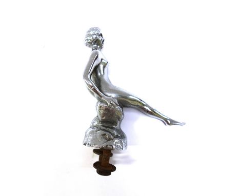 A nickel plated bronze car mascot modelled and cast as a Speed Nymph seated atop a rock, stamped 'AEL' to rear, 11.5cm high.