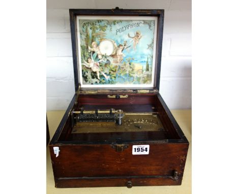A Victorian polyphon housed in a painted pine case, with sixteen polyphon disks, the case 26cm wide.