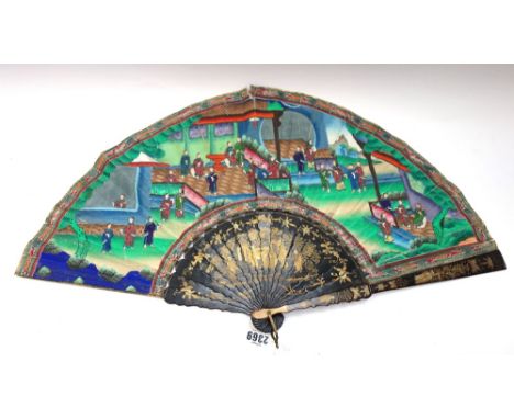 A Chinese gilt lacquer and painted paper fan, 19th century, the sticks gilt heightened with an assemblage of courtly figures,