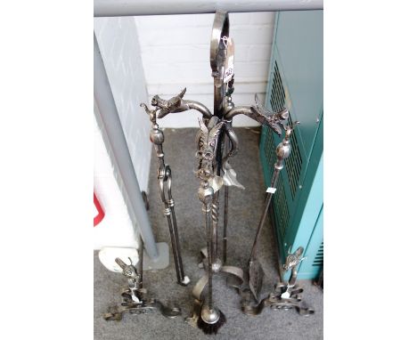 A set of steel fire irons on a stand with dragon finials, matching andirons (98cm high), and a steel curved fire screen.