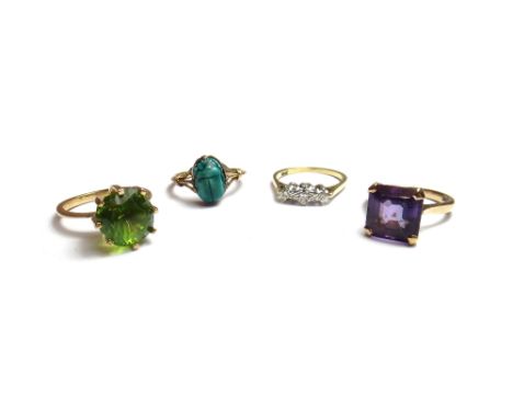 A gold ring, claw set with a cushion shaped peridot, a gold ring, claw set with a square step cut amethyst, a gold and diamon