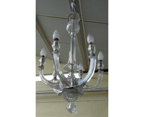 A clear glass six branch chandelier, early 20th century, with globular finial over a hexagonal tapering stem, issuing six pla
