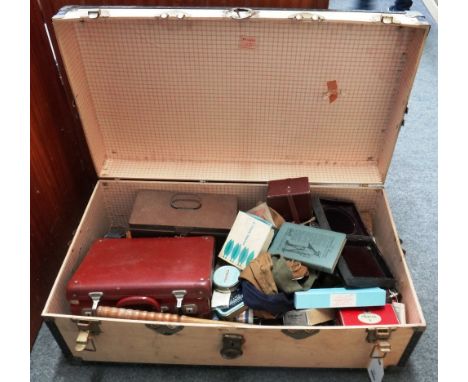 A quantity of vintage fishing floats, lures, rod bags, landing nets, reel cases and accessories, contained in a plywood trunk