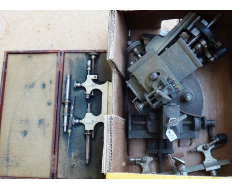 A steel tour pivoter, two watchmakers depthing tools, part of a metalwork lathe, and two other mechanical lathe pieces.