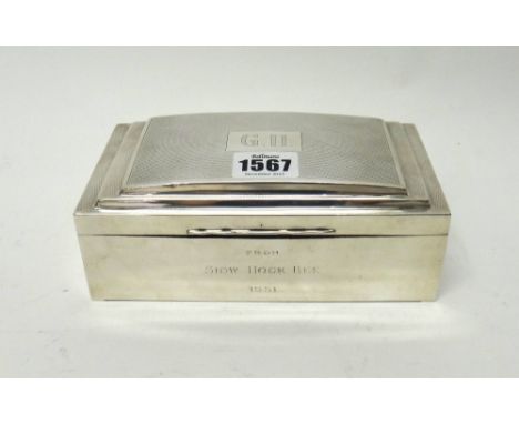 A silver rectangular table cigarette box, wooden lined within, presentation inscribed to the front, the lid engine turned and