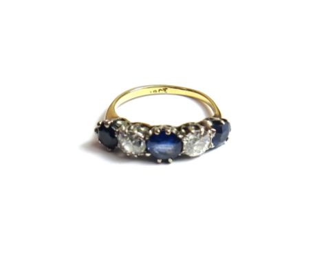 A gold, sapphire and diamond set five stone ring, claw set with three cushion shaped sapphires, alternating with two cushion 