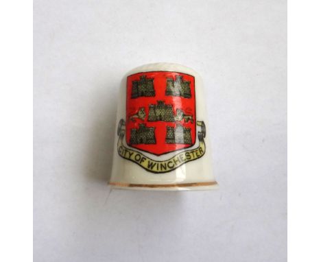 An Arcadian China crested souvenir ware thimble with polychrome decoration of coat of arms of Hythe, black printed mark to th