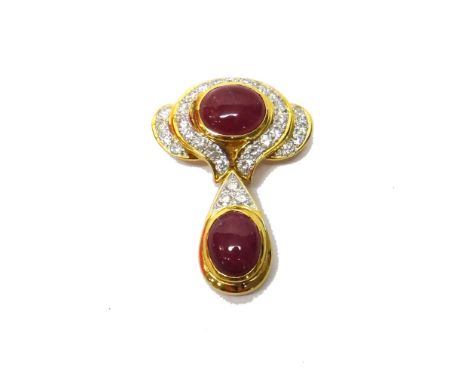 A gold, diamond and ruby set pendant/brooch, of twin section form, mounted with two oval cabochon rubies and otherwise set wi
