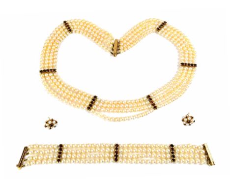 A gold mounted, cultured pearl and garnet set collar necklace, formed as four rows of cultured pearls, with garnet set five s