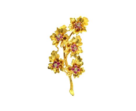 An 18ct gold, ruby and diamond set brooch, designed as a floral and foliate spray, mounted with five ruby and diamond set clu